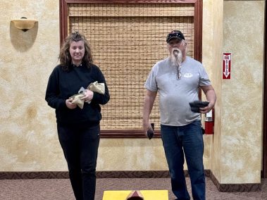 two adults playing cornhole